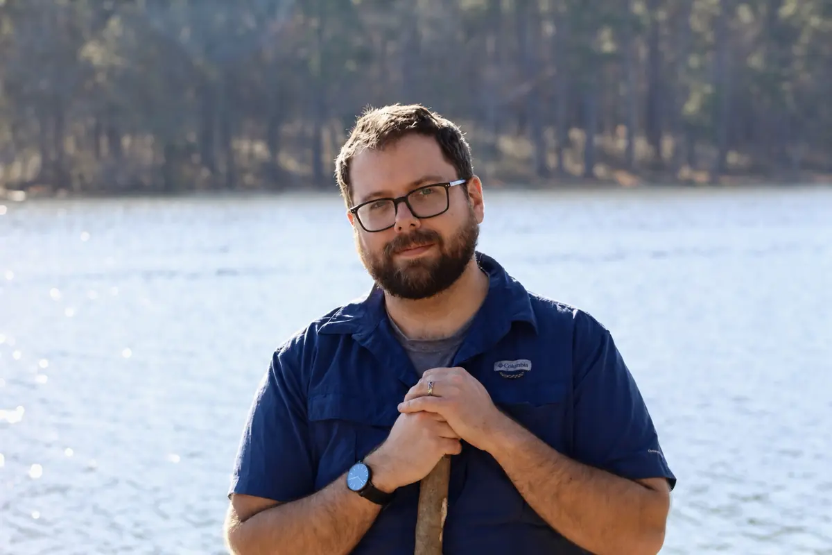 David C. Molik standing beside a lake